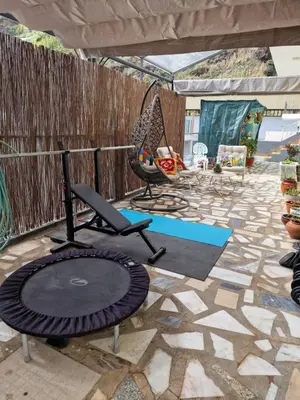 a living room with a blue couch and a table at Nature Brava Stay in Ribeira Brava