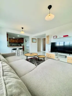 a living room with a couch and a flat screen tv at The West House in Calheta