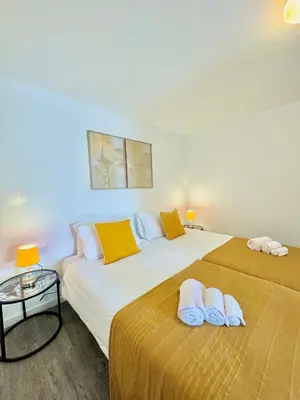 two beds sitting next to each other in a room at The West House in Calheta