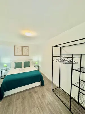 a bedroom with a bed and two side tables at The West House in Calheta