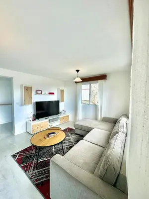 a living room with a couch and a table at The West House in Calheta