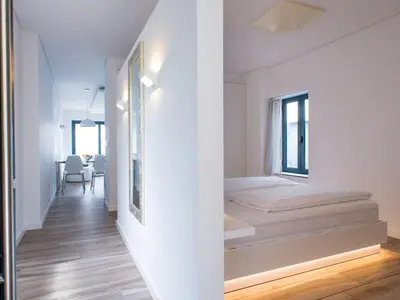 a bedroom with a bed in a white room at Quinta Golfinho - Villa Palmeira in Arco da Calheta