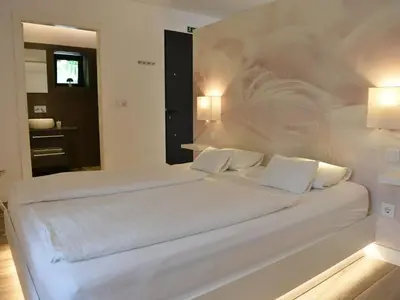 a white bedroom with a large bed with white pillows at Quinta Golfinho - Villa Palmeira in Arco da Calheta