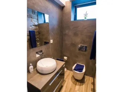a bathroom with a toilet and a sink and a window at Quinta Golfinho - Villa Rosa in Arco da Calheta