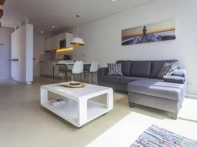 a living room with a couch and a table at Holoiday home Casa Estrelizia in Arco da Calheta