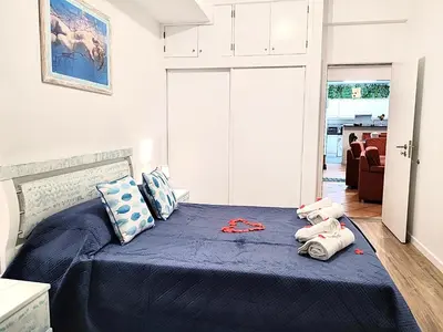 a bedroom with a blue bed with towels on it at SeaView in Porto Santo