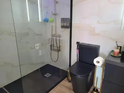 a bathroom with a toilet and a glass shower at SeaView in Porto Santo