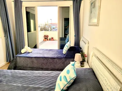 two beds in a room with a mirror at SeaView in Porto Santo