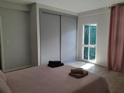 a bedroom with a bed with two towels on it at Northern Air House in São Vicente