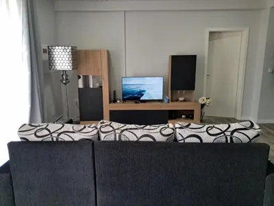 a living room with a couch and a tv at Northern Air House in São Vicente