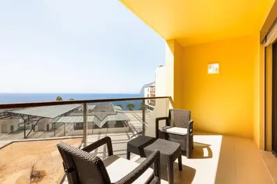 a balcony with chairs and a view of the ocean at GuestReady – Madeira escape with ocean view in Funchal