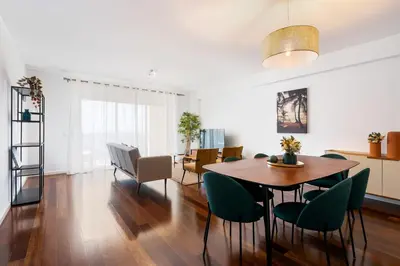 a dining room and living room with a table and chairs at GuestReady – Madeira escape with ocean view in Funchal