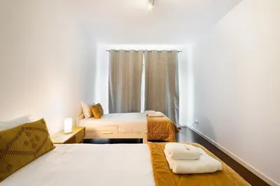 a bedroom with two beds and a window at GuestReady – Madeira escape with ocean view in Funchal