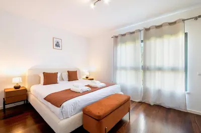 a bedroom with a large bed and a large window at GuestReady – Madeira escape with ocean view in Funchal