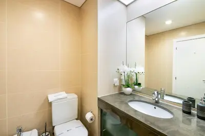 a bathroom with a toilet and a sink and a mirror at GuestReady – Madeira escape with ocean view in Funchal