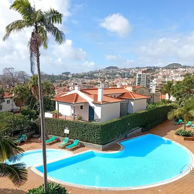an image of a swimming pool in front of a house at Apartamento Silvestre Freitas in Funchal
