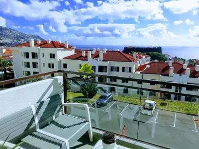 a balcony with a view of a parking lot at H&F Fort View Apartment in Funchal
