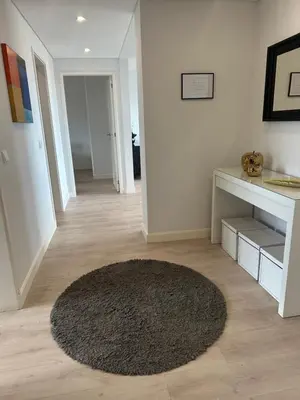 a living room with a rug on a wooden floor at H&F Fort View Apartment in Funchal