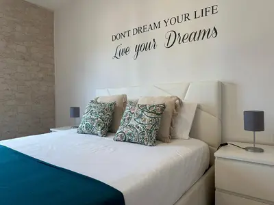 a bedroom with a bed with the words dont dream your life live your dreams at H&F Fort View Apartment in Funchal