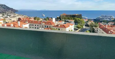 a view of a city with the ocean and buildings at H&F Fort View Apartment in Funchal
