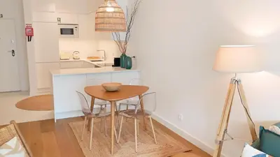 a small kitchen with a table and chairs in a room at FLH Ocean View Escape at Acqua Residences in Funchal