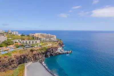 an aerial view of a resort on a cliff next to the ocean at FLH Ocean View Escape at Acqua Residences in Funchal