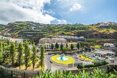 an aerial view of a city with a fountain at Modern Studio Steps From Beach in Ponta do Sol