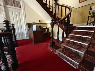a living room with two chairs and a red carpet at Mirasol Guesthouse in Funchal