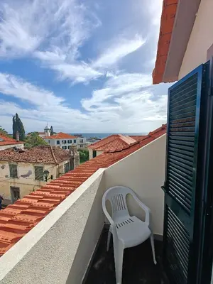 a view of the ocean from the roofs of buildings at Mirasol Guesthouse in Funchal