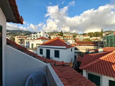 a small bedroom with a bed and a window at Mirasol Guesthouse in Funchal