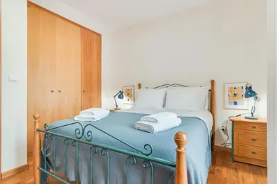 a bedroom with a blue bed with two towels at Ribeira brava - duplex sea view in Ribeira Brava