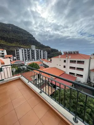 a balcony with a view of buildings and mountains at Ribeira brava - duplex sea view in Ribeira Brava