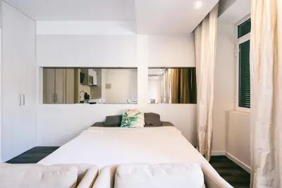 a bedroom with a large white bed in a room at Funchal City Studio in Funchal
