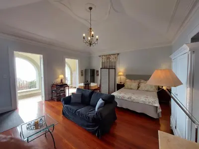 a living room with a couch and a bed at Elegant and Relaxing Seaview Apartment with Pool in Funchal