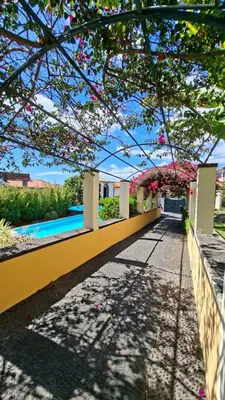 a view from the garden of a house with flowers at Elegant and Relaxing Seaview Apartment with Pool in Funchal