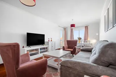 a living room with a couch and a tv at Atlantic Paradise in Caniço