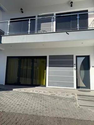 a building with two garage doors and a balcony at D - DELIGHTFUL Cottage with FREE Private Parking in Machico