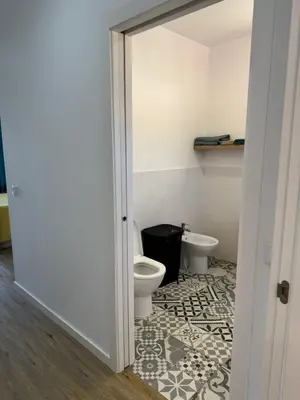 a bathroom with a toilet and a sink at D - DELIGHTFUL Cottage with FREE Private Parking in Machico