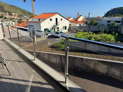a metal railing on a roof of a house at D - DELIGHTFUL Cottage with FREE Private Parking in Machico