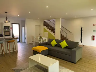a living room with a couch and a table at D - DELIGHTFUL Cottage with FREE Private Parking in Machico