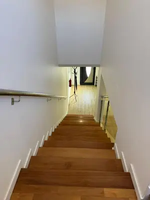 a staircase in a building with white walls and wooden floors at D - DELIGHTFUL Cottage with FREE Private Parking in Machico