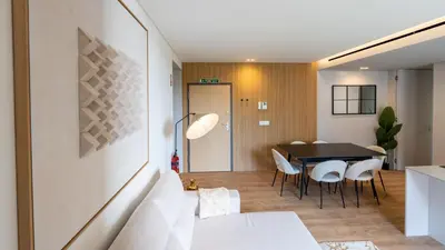 a living room with a table and white chairs at Orion Calheta Hills by LovelyStay in Estreito da Calheta