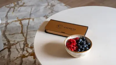 a small cup of berries and a box on a table at Orion Calheta Hills by LovelyStay in Estreito da Calheta