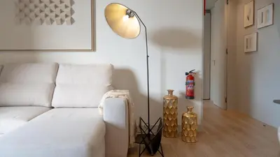 a living room with a white couch and a floor lamp at Orion Calheta Hills by LovelyStay in Estreito da Calheta