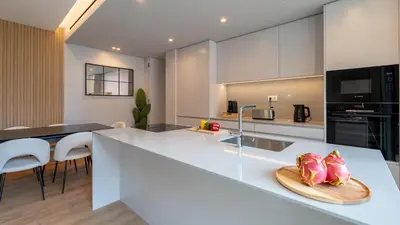a kitchen with a counter with a plate of fruit on it at Orion Calheta Hills by LovelyStay in Estreito da Calheta