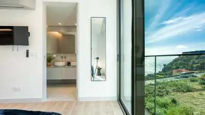 a kitchen and dining room with a view of the ocean at Orion Calheta Hills by LovelyStay in Estreito da Calheta