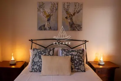 a bedroom with a bed with a nautical sign on the wall at Feiteiras House by Escape to Madeira in Ponta do Sol
