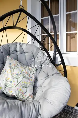 a chair with a pillow on it next to a window at Feiteiras House by Escape to Madeira in Ponta do Sol