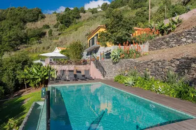 a swimming pool in front of a house at Casa da Laranja by Holiday Rental Madeira in Tábua
