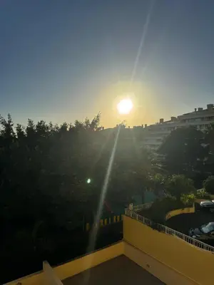 a view of the sunset from the balcony of a building at Ajuda Mar Holidays in Funchal
